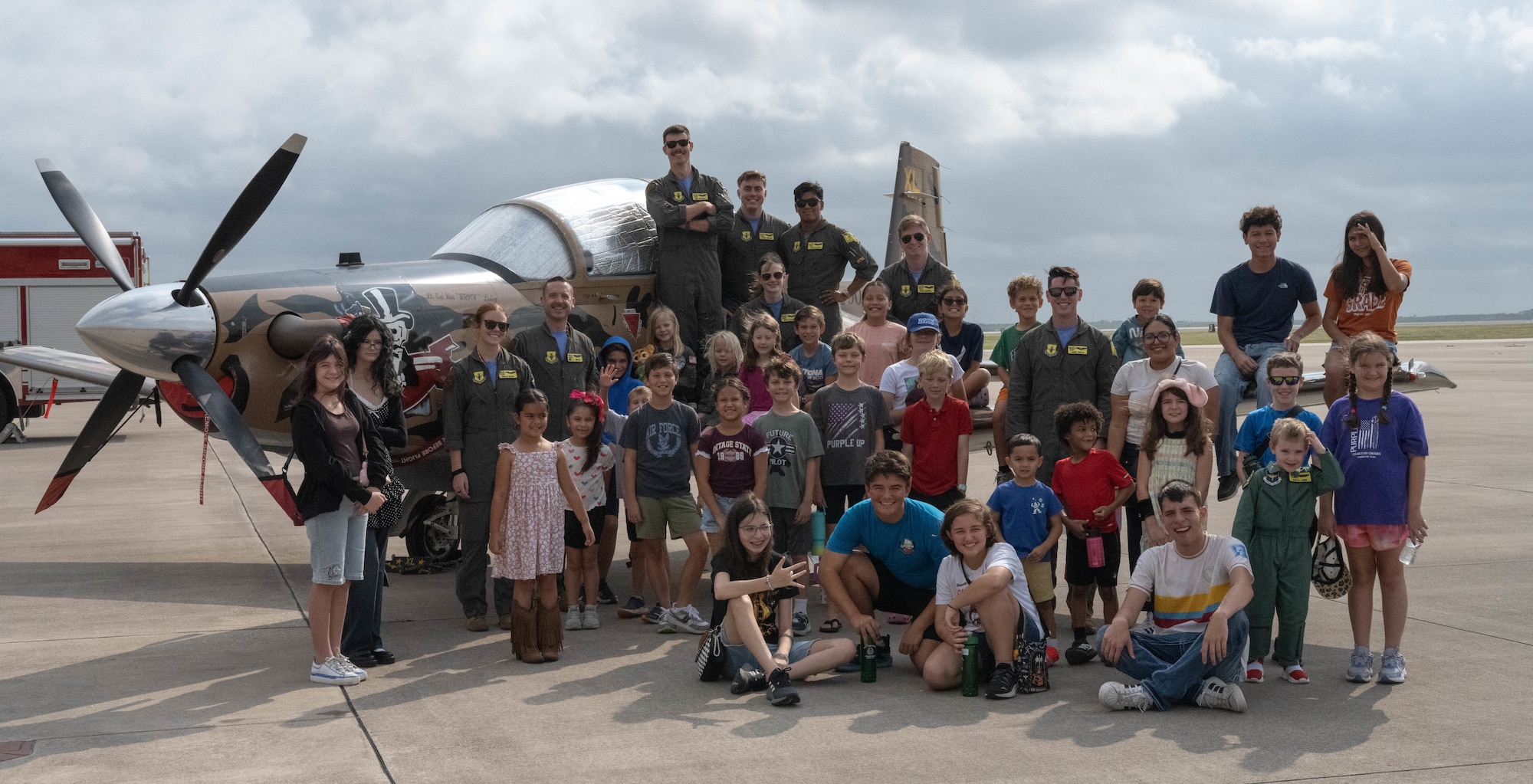 U.S. Air Force Airmen assigned to the 85th Flying Training Squadron (FTS) and participants of Tiger for a Day come together for a group photo at Laughlin Air Force Base, Texas, Aug. 5, 2026. The event was held by the 85th FTS to showcase their heritage and mission to students in the local area. (U.S. Air Force photo by Airman 1st Class Darryl Keith)