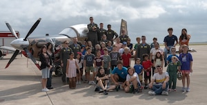 U.S. Air Force Airmen assigned to the 85th Flying Training Squadron (FTS) and participants of Tiger for a Day come together for a group photo at Laughlin Air Force Base, Texas, Aug. 5, 2026. The event was held by the 85th FTS to showcase their heritage and mission to students in the local area. (U.S. Air Force photo by Airman 1st Class Darryl Keith)