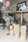 Warrant Officer 1 Brennan McHugh, signals intelligence technician for the 556th Military Intelligence Co., 56th Mobile Brigade Combat Team, programs emitters with simulated enemy communications during a multi-domain exercise Aug. 3, 2026 at Fort Indiantown Gap, Pennsylvania. (Pennsylvania National Guard photo by Brad Rhen)