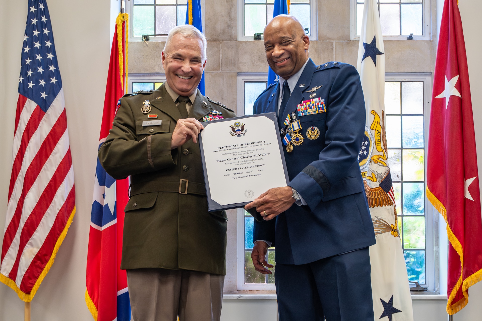 U.S. Army Maj. Gen. Haldane Lamberton, left, adjutant general of the Kentucky National Guard, presents U.S. Air Force Maj. Gen. Charles Walker, Air National Guard assistant to the judge advocate general of the United States Air Force, with a certificate of retirement during a ceremony in Nashville, Tenn., July 24, 2026. Walker is concluding a distinguished 35-year career during which he previously served as director of the Office of Complex Investigations at the National Guard Bureau in Washington, D.C., chief of staff for the Air Component at Joint Force Headquarters—Kentucky National Guard, and staff judge advocate for the Kentucky Air Guard’s 123rd Airlift Wing in Louisville. (U.S. Air National Guard photo by Dale Greer)