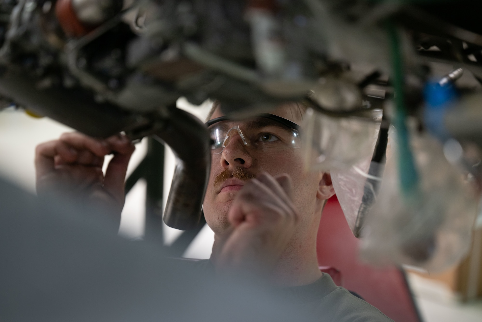 A military member works on an engine