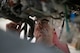 A military member works on an engine