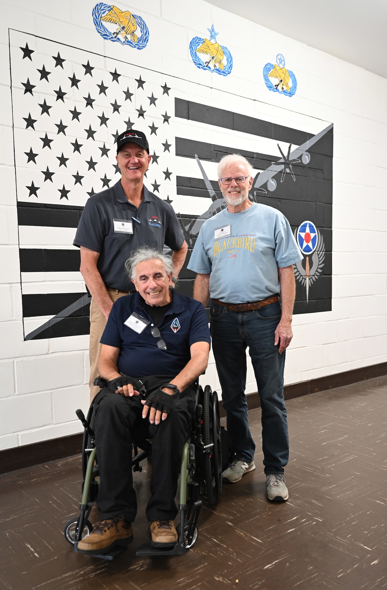 U.S. Air Force Master Sgt (ret.) Robert Butterfield, center, former SR-71 Blackbird crew chief; his guest, Wade Vaughn, left, and Maj. (ret.) Robert Rieser, former SR-71 intelligence officer, pose for a photo at RAF Mildenhall, England, July 27, 2026. The SR-71 veterans, along with their families and members of the RAF Sculthorpe Heritage Centre, received mission briefings and a tour of the base. The Blackbird was assigned to Detachment 4, 9th Reconnaissance Wing, attached to RAF Mildenhall from 1976 to 1990, and 2026 marks the 50th anniversary of its arrival here. (U.S. Air Force photo by Karen Abeyasekere)