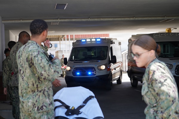 Hospital corpsmen prepare to receive simulated casualties as an ambulance arrives at U.S. Naval Hospital Rota during a mass casualty exercise at Naval Station Rota, Spain, June 25, 2026. The exercise tested emergency-response procedures, patient movement and coordination among medical personnel and installation first responders. (U.S. Navy photo by Hospital Corpsman 2nd Class Ahmi Atsina)