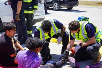 Naval Station Rota emergency responders and emergency medical technicians from U.S. Naval Hospital Rota assess and treat simulated casualties at the scene of an aircraft crash during a mass casualty exercise in Rota, Spain, June 25, 2026. The exercise tested on-scene triage, emergency medical care, and coordination between installation first responders and U.S. Naval Hospital Rota. (U.S. Navy photo by Hospital Corpsman 2nd Class Ahmi Atsina)