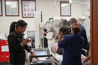 U.S. Navy Hospital Corpsman 2nd Class Kezia Allegue Navarro, left, a radiologic technologist, operates portable X-ray equipment while medical personnel evaluate a simulated casualty during a mass casualty exercise at U.S. Naval Hospital Rota, Naval Station Rota, Spain, June 25, 2026. The training tested patient assessment, diagnostic imaging procedures and coordinated care during a large-scale emergency response. (U.S. Navy photo by Hospital Corpsman 2nd Class Ahmi Atsina)