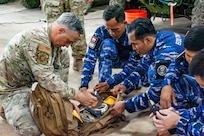 U.S. Air Force Master Sgt. Dustin Frey, 154th Explosive Ordnance Disposal, or EOD, flight technician, presents and reviews hook and line equipment to the Indonesian Air Force EOD on Andersen Air Force Base, Guam, July 21, 2026.