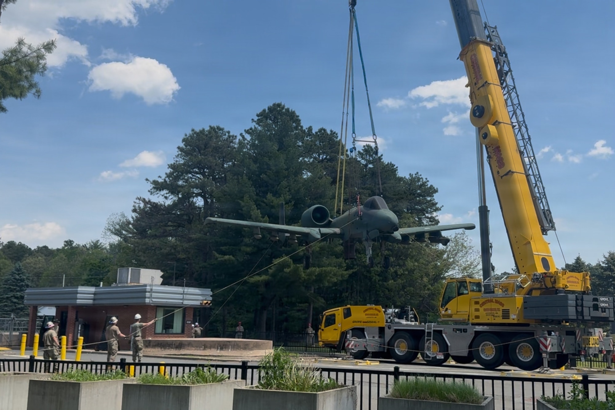 Members of the 104th Fighter Wing crashed, damaged, disabled, aircraft recovery (CDDAR) team hold a rope while an A-10 Thunderbolt II hangs from a crane, at Barnes Air National Guard Base, May 21, 2026, Westfield, Mass. The A-10 Thunderbolt II was lifted from the concrete pedestal that had held it since 25 September 1997 in order to be placed in a new location on base.

(U.S. Air National Guard Photo by Melanie J. Casineau)