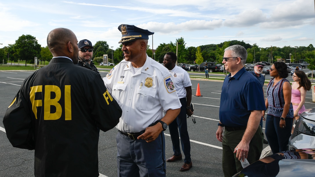 Representatives from federal and local public safety agencies speak with community members