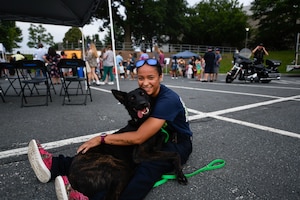 Raina Jenkins, an Arbutus Volunteer Fire Department member, poses with her dog