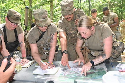 Soldiers from the Pennsylvania National Guard's 556th Military Intelligence Company, 56th Mobile Brigade Combat Team determine a simulated enemy position during a multi-domain exercise Aug. 3, 2026 at Fort Indiantown Gap, Pennsylvania.