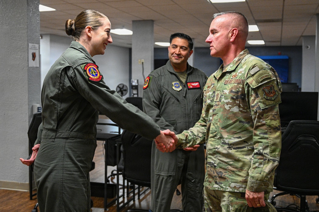 Airmen shake hands with CMSgt Wolfe