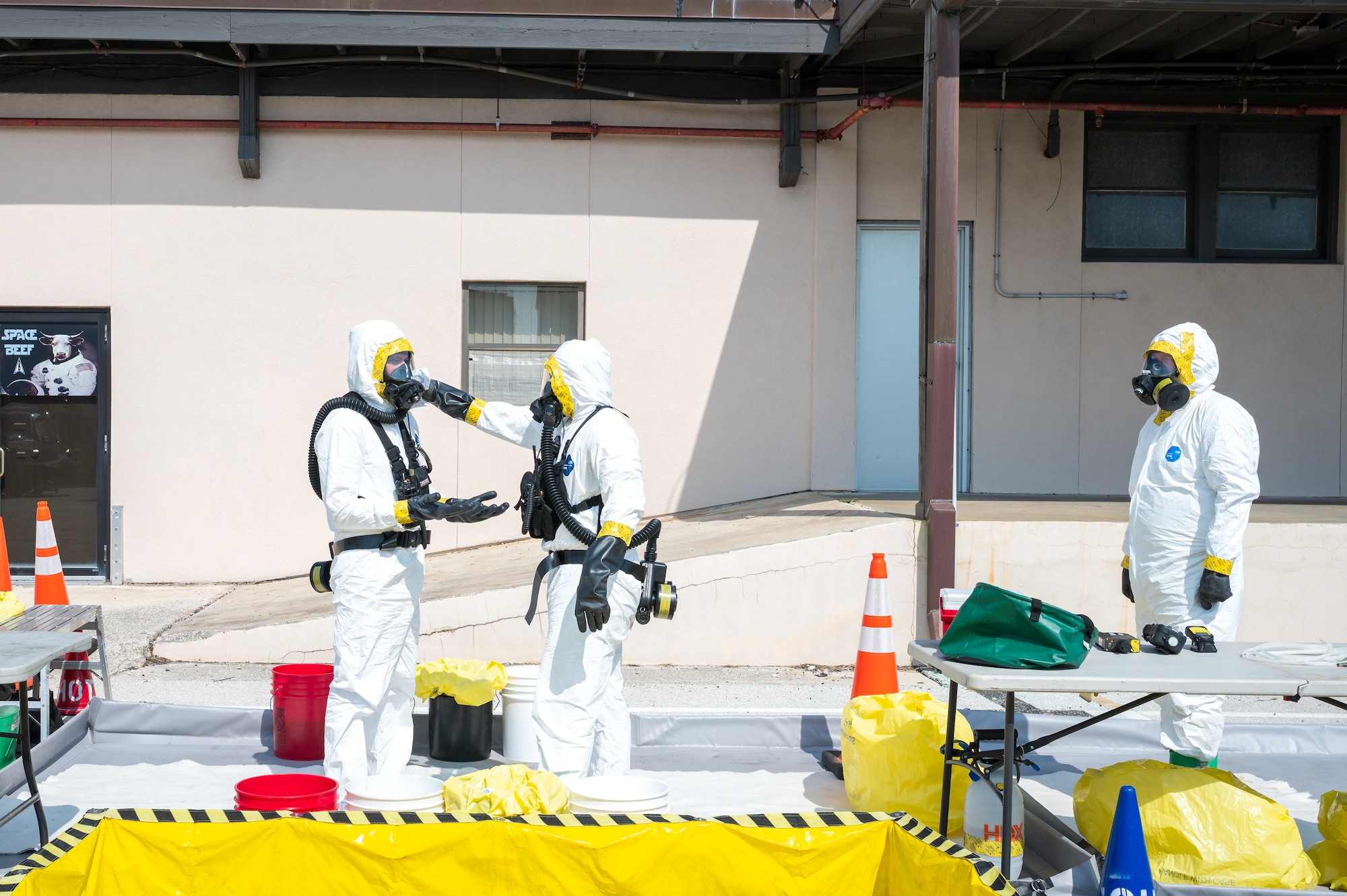 Space Launch Delta 45 Emergency Management personnel and members of the Florida National Guard’s 44th Weapons of Mass Destruction Civil Support Team conduct a joint hazardous materials response training exercise at Patrick Space Force Base, Fla., July 28, 2026. Decontamination personnel conduct a protective-equipment check within an established decontamination corridor before responders enter or leave the simulated hot zone. (U.S. Space Force photo by Gwendolyn Kurzen)