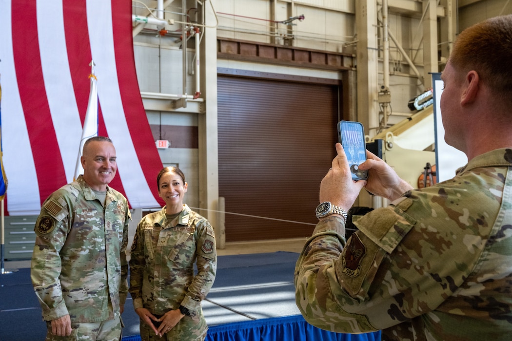 Airmen take photo of CMSgt Wolfe and Airman