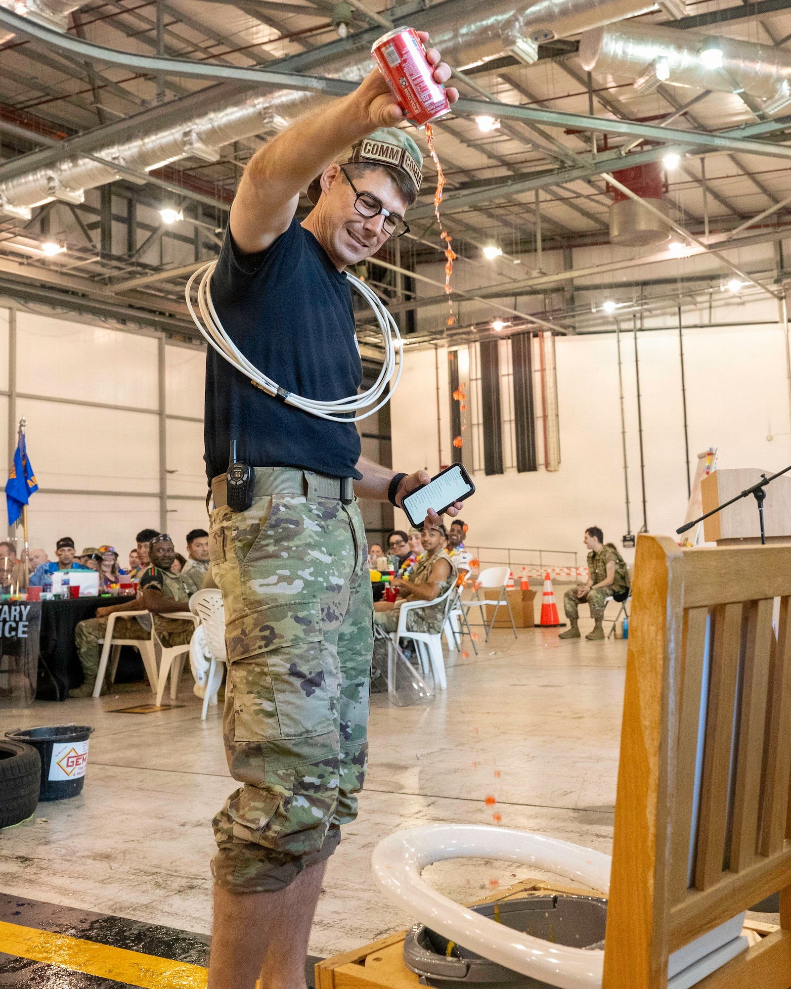 Attendee contributes to a Grog Bowl during a combat dining-in