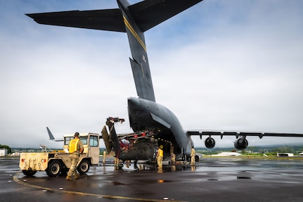 Hawaii Army National Guard Soldiers and Hawaii Air National Guard Airmen prepare to load a Hawaii Army National Guard UH-60M Black Hawk helicopter aboard a Hawaii Air National Guard C-17 Globemaster III assigned to the 204th Airlift Squadron at Hilo International Airport, July 31, 2026.
