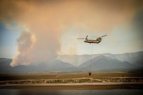 A Nevada Army Guard CH-47 Chinook departs for the Ward Fire near Ely, Nevada, on Saturday. After several days of intense aerial suppression efforts, the Nevada Army National Guard and fire officials with the U.S. Forest Service report that the Ward Fire has jumped to 27 percent containment, positive news for the blaze just south of Ely.
