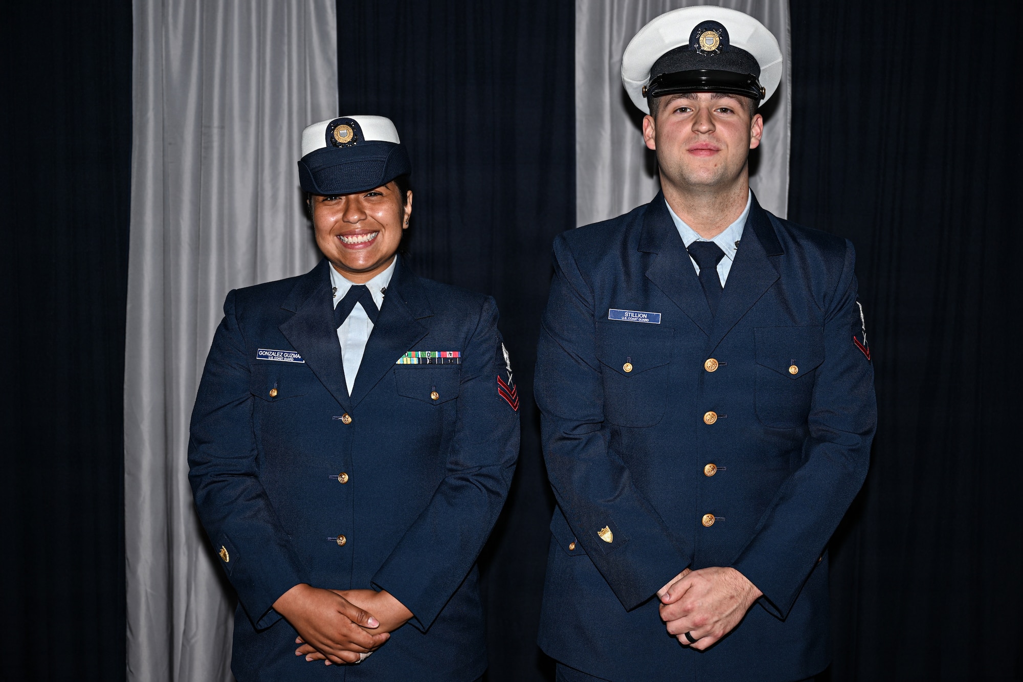 From left, U.S. Coast Guardsmen Yeoman Second Class Moisabley Gonzalez Guzman and Yeoman Third Class Maxwell Stillion, assigned to the Coast Guard Pay and Personnel Center in Topeka, Kansas, pose for a photo at McConnell Air Force Base, Kansas, July 6, 2026. For the first time in McConnell history, two Coast Guardsmen joined Airman Leadership School class 26-F. (U.S. Air Force photo by Senior Airman Amelio Brown)