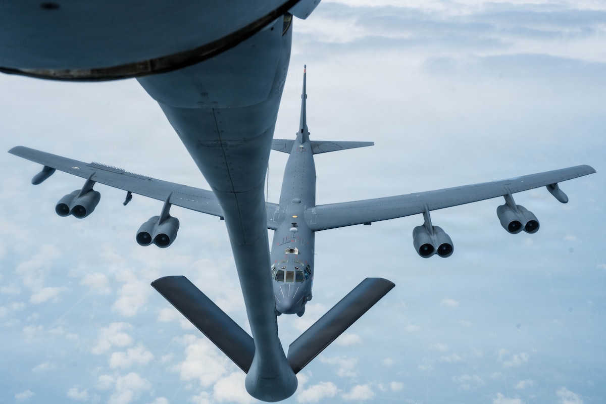 A B-52 Stratofortress assigned to the 5th Bomb Wing holds its distance behind a KC-135 Stratotanker assigned to the 22nd Air Refueling Wing