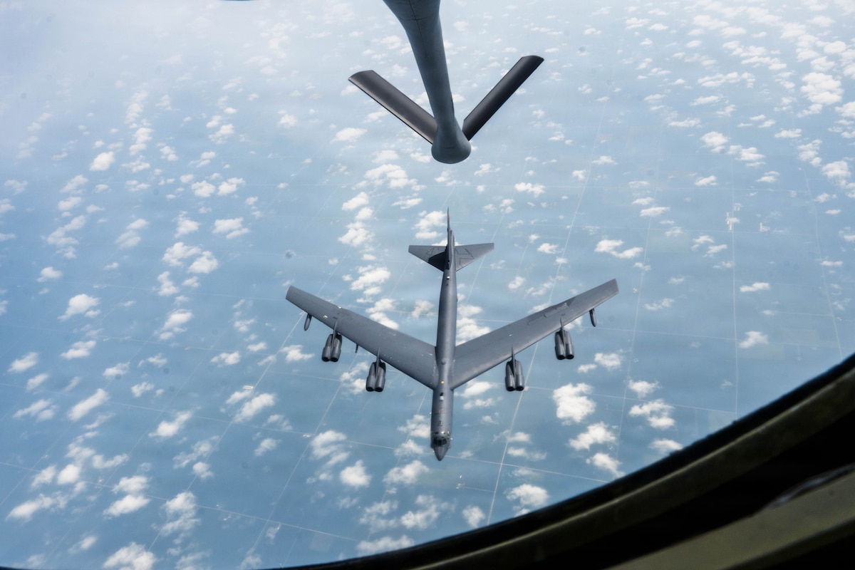 A B-52 Stratofortress assigned to the 5th Bomb Wing flies below a KC-135 Stratotanker assigned to the 22nd Air Refueling wing