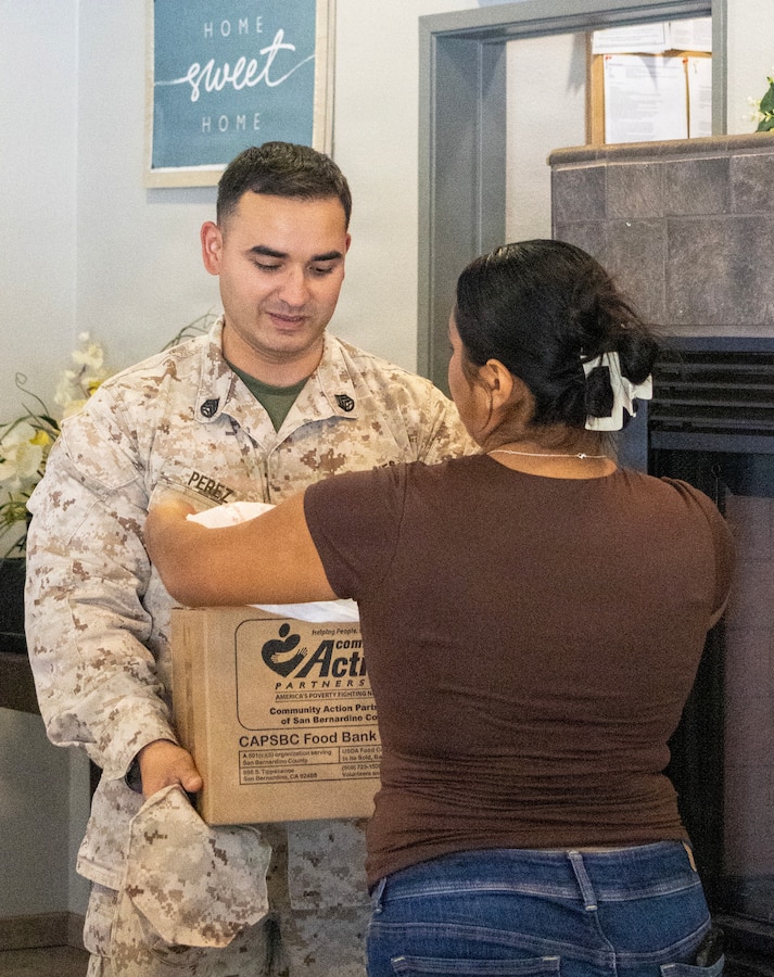 MARINE CORPS LOGISTICS BASE BARSTOW, Calif. — Military families, Marines, civilians, and base personnel gathered for a food and toiletry distribution event at the Housing Community Center aboard Marine Corps Logistics Base Barstow, California, Aug. 4. The event was held to provide military families with donated food and toiletry items sponsored by Community Action Partnership of San Bernardino County. (U.S. Marine Corps photos by Katherine Cortez, COMMSTRAT)