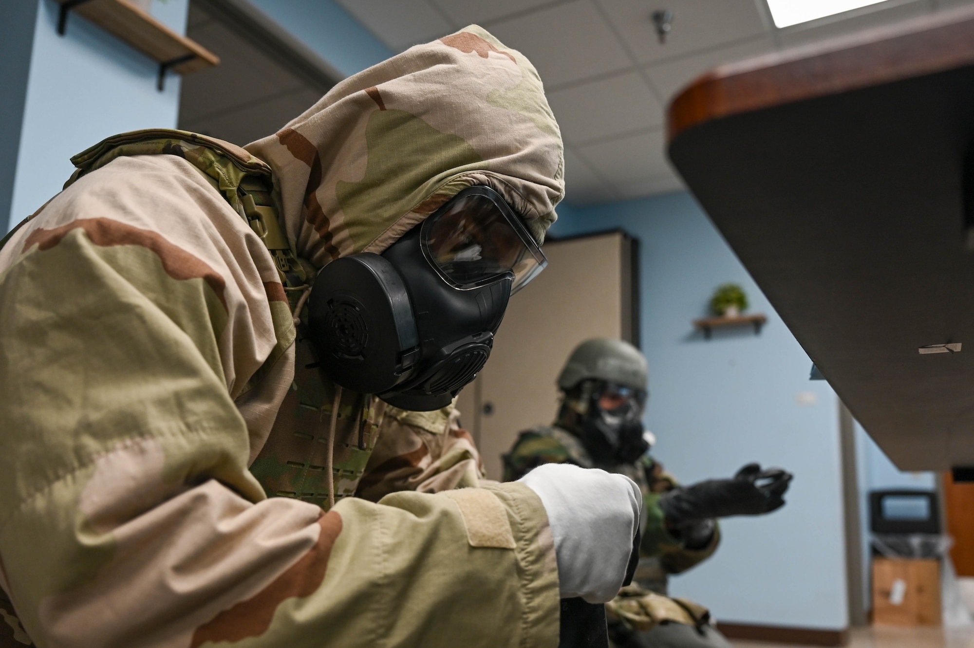 An Airmen puts on military gear