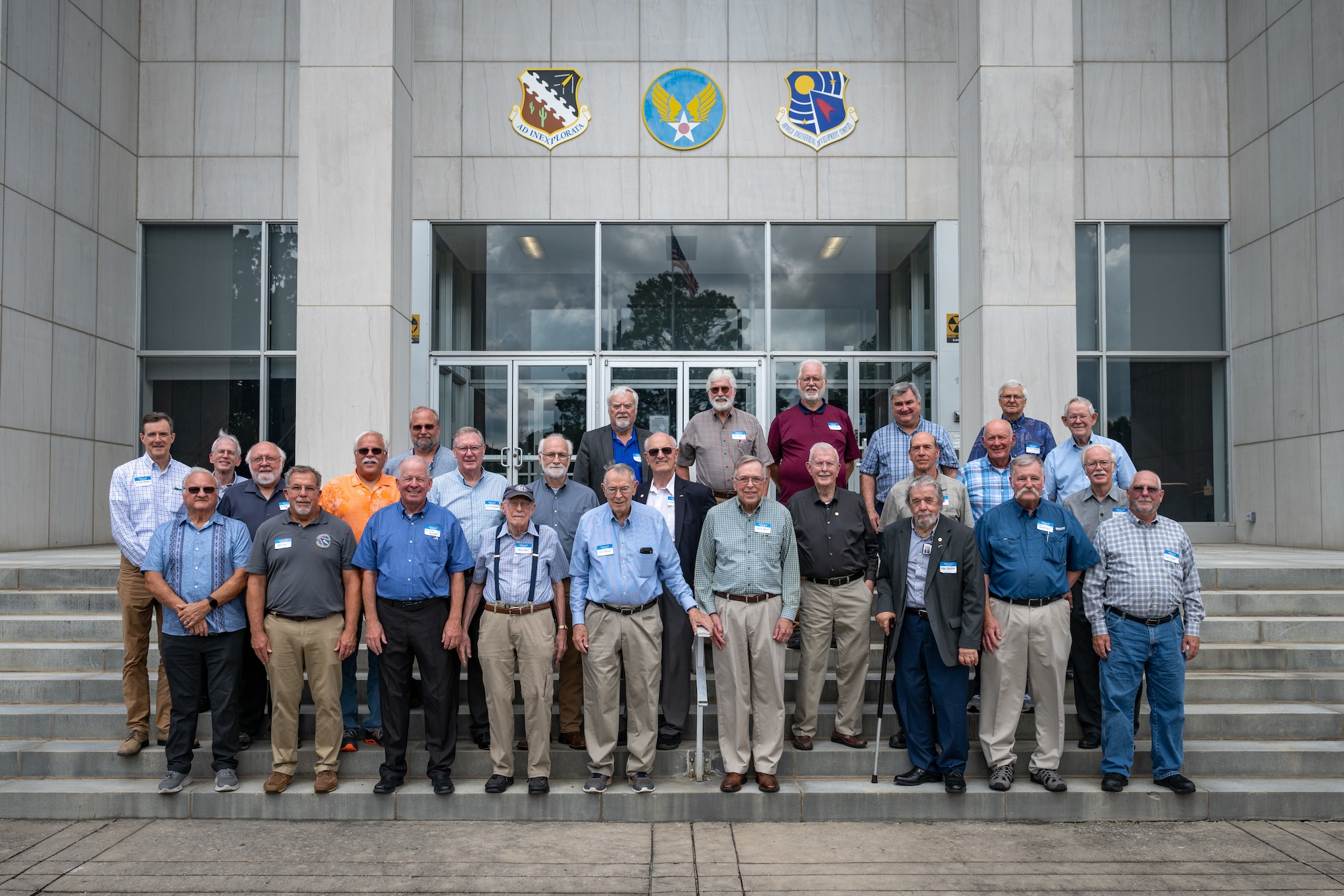 Arnold Engineering Development Complex Fellows gather for a photo on the steps of the Administration and Engineering Building at Arnold Air Force Base, Tenn., during AEDC Fellows Day, Aug. 5, 2026. AEDC is headquartered at Arnold AFB. The AEDC Fellows program, established in 1989 and managed by the Arnold Community Council, recognizes AEDC personnel who have made substantial and exceptionally distinguished contributions to the nation’s aerospace ground testing capability. This year, Ryan Bond, Ph.D.; Chester Furlong; Sam Dougherty; Randy Nicholson and Johannes van Aken, Ph.D., were induced as AEDC Fellows. The newly selected Fellows were recognized during the AEDC 75th anniversary open house event held June 27 at Arnold AFB. (U.S. Air Force photo by Keith Thornburgh)