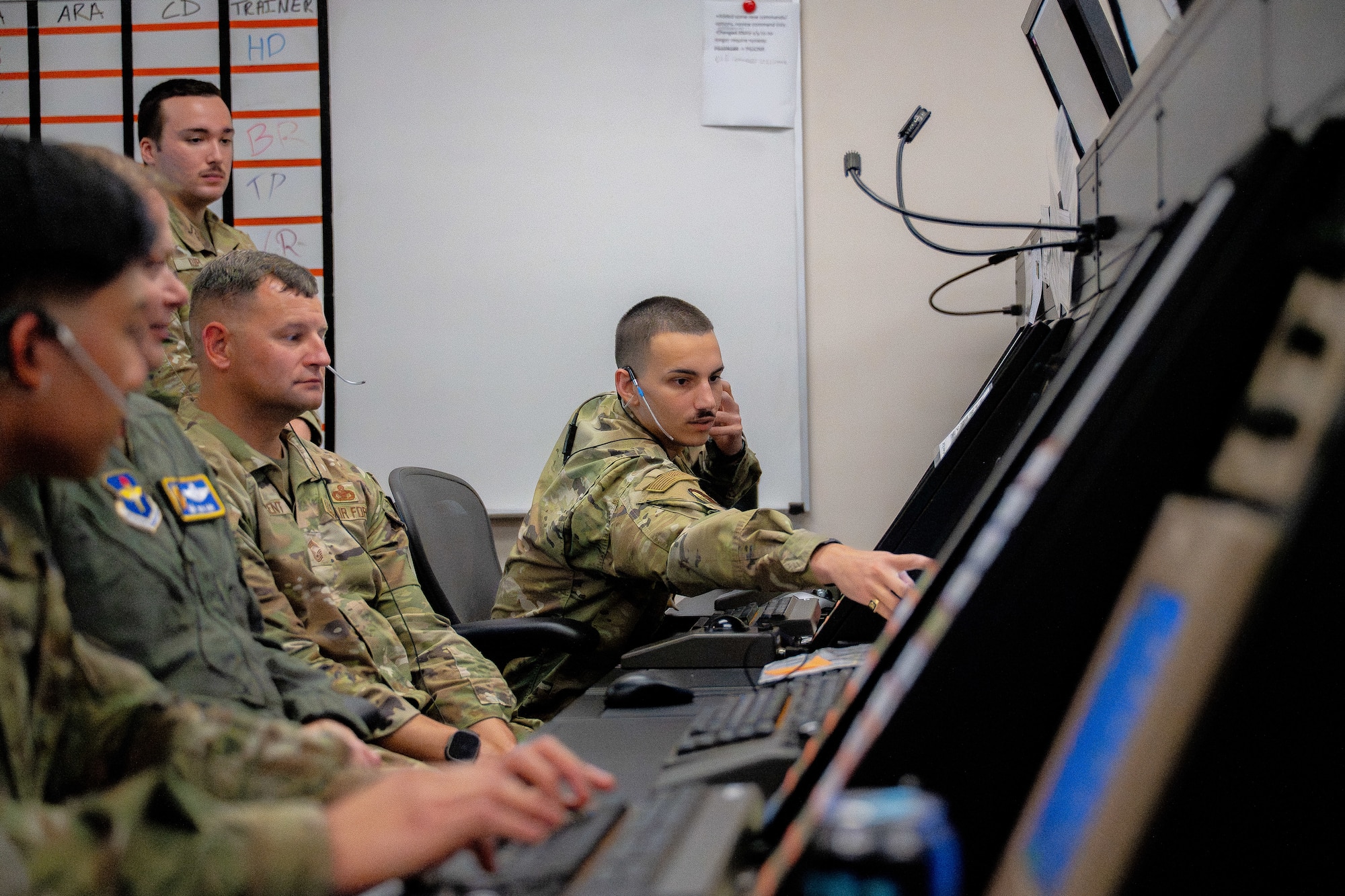 U.S. Air Force Senior Airman Vincent Rotolo, 97th Operations Support Squadron air traffic control radar approach control trainer, demonstrates how to use the Standard Terminal Automation Replacement System simulator at Altus Air Force Base, Oklahoma, Aug. 4, 2026. As a part of a hands-on immersion tour with the 97th OSS, the command team engaged with personnel assigned to Altus’ air traffic control tower and RAPCON. (U.S. Air Force photo by Airman 1st Class Emma Wright)