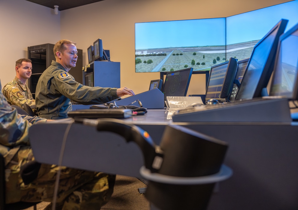 U.S. Air Force Col. Richard Kind, 97th Air Mobility Wing commander, adjusts the flight progress strips while using the Tower Simulation System at Altus Air Force Base, Oklahoma, Aug. 4, 2026. During a hands-on immersion tour with the 97th Operations Support Squadron, the command team had the opportunity to use simulation systems for both the tower and radar approach control. (U.S. Air Force photo by Airman 1st Class Emma Wright)