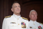 Vice Adm. James P. Downey, commander, Naval Sea Systems Command (NAVSEA) and Portfolio Acquisition Executive Industrial Operations (PAE IO) (left) stands at attention with Capt. Daniel L. Mode, NAVSEA Chaplain on stage at a change of command and change of office ceremony on Aug. 6, at the Washington Navy Yard in Washington, D.C. Downey was relieved of his dual-hatted role as commander, NAVSEA by Rear Adm. Peter Small and as PAE IO by  Rear Adm. Todd Weeks. (US. Navy photo by Matthew Rakola)