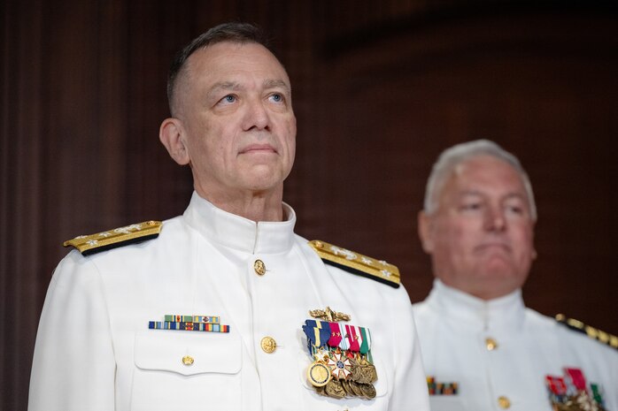 Vice Adm. James P. Downey, commander, Naval Sea Systems Command (NAVSEA) and Portfolio Acquisition Executive Industrial Operations (PAE IO) (left) stands at attention with Capt. Daniel L. Mode, NAVSEA Chaplain on stage at a change of command and change of office ceremony on Aug. 6, at the Washington Navy Yard in Washington, D.C. Downey was relieved of his dual-hatted role as commander, NAVSEA by Rear Adm. Peter Small and as PAE IO by  Rear Adm. Todd Weeks. (US. Navy photo by Matthew Rakola)