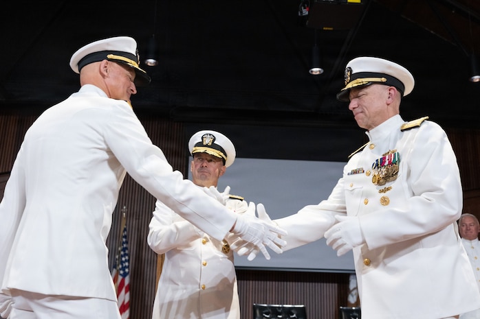 Rear Adm. Todd S. Weeks (left) shakes hands with Vice Adm. James P. Downey, commander, Naval Sea Systems Command (NAVSEA) and Portfolio Acquisition Executive Industrial Operations (PAE IO), as Adm. James W. Kilby, Vice Chief of Naval Operations looks on, during a joint change of office and command ceremony on the Washington Navy Yard, Aug. 6. Downey was relieved of his dual-hatted role as commander, NAVSEA by Rear Adm. Peter Small and as PAE IO by Weeks. (U.S. Navy photo by Matthew Rakola.)