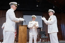 Rear Adm. Peter D. Small (left) with Adm. James W. Kilby, Vice Chief of Naval Operations (center) and Vice Adm. James P. Downey applaud during a joint change of office and command ceremony on the Washington Navy Yard, Aug. 6. Downey was relieved of his dual-hatted role as commander, Naval Sea Systems Command by Small and as Portfolio Acquisition Executive Industrial Operations by Rear Adm. Todd Weeks. (U.S. Navy photo by Matthew Rakola)
