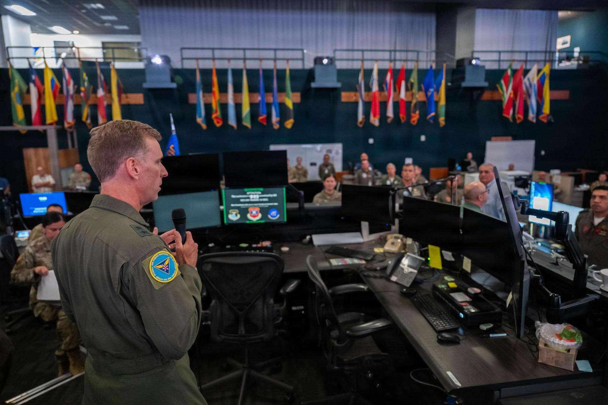 U.S. Air Force Maj. Gen. David Mineau, Twelfth Air Force (Air Forces Southern) Commander and Joint Force Air Component Commander, addresses multinational participants during the opening day of Exercise PANAMAX 2026 inside the Combined Air Operations Center at Davis-Monthan Air Force Base, Arizona, Aug. 3, 2026. PANAMAX 2026 seeks to improve interoperability and strengthen collective capacity to conduct complex multinational and all-domain operations to ensure free flow of commerce through the Panama Canal and maintain security and stability in the region.