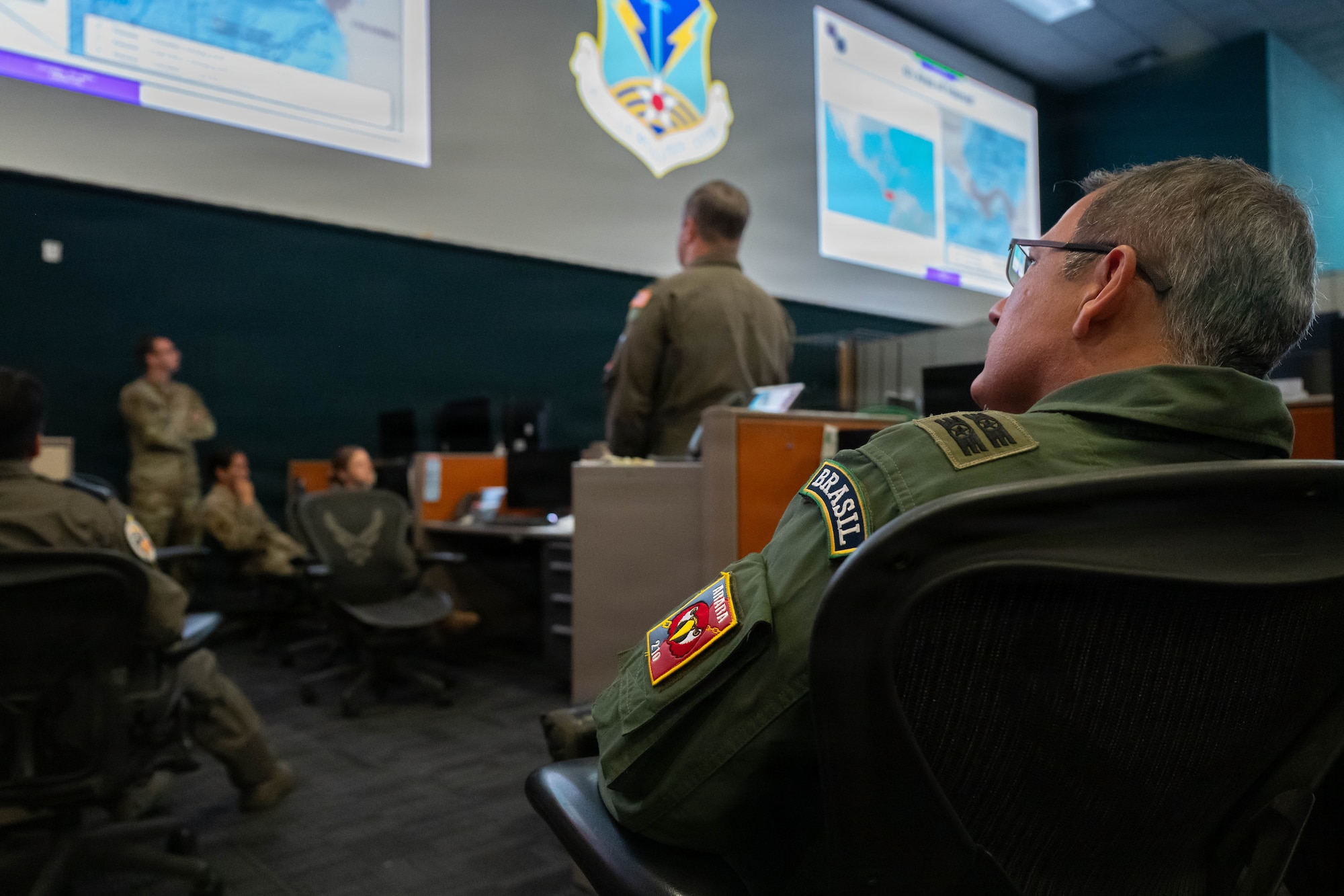 A Brazilian air force officer participates in a multinational briefing during the opening day of Exercise PANAMAX 2026 inside the Combined Air Operations Center at Davis-Monthan Air Force Base, Arizona, Aug. 3, 2026. PANAMAX 2026 seeks to improve interoperability and strengthen collective capacity to conduct complex multinational and all-domain operations to ensure free flow of commerce through the Panama Canal and maintain security and stability in the region.