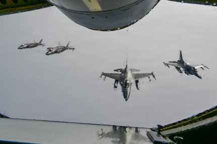 Two U.S. Air Force F-16 Fighting Falcons and F-35A Lightning II’s fly in formation in the North American Aerospace Defense Command Area of Responsibility, Aug 4, 2026. (U.S. Air Force photo by Senior Airman Spencer Hanson)