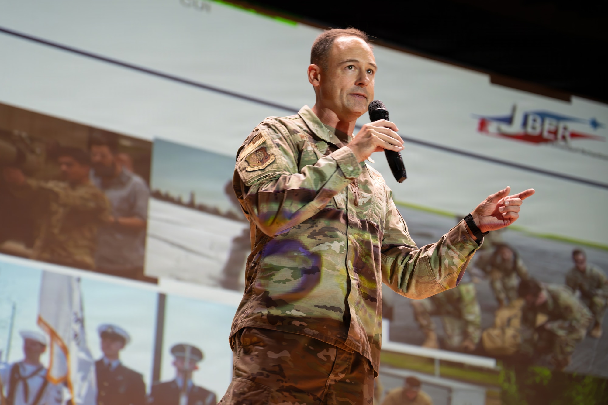 U.S. Air Force Col. Daniel C. Werner, 673d Air Base Wing and Joint Base Elmendorf-Richardson commander, addresses base personnel during his first all-call as new commander at Talkeetna Theater on JBER, Alaska, July 31, 2026. Military leadership utilize all-call meetings to relay important information to base personnel and organizations. (U.S. Air Force photo by Airman 1st Class Thomas Polk)