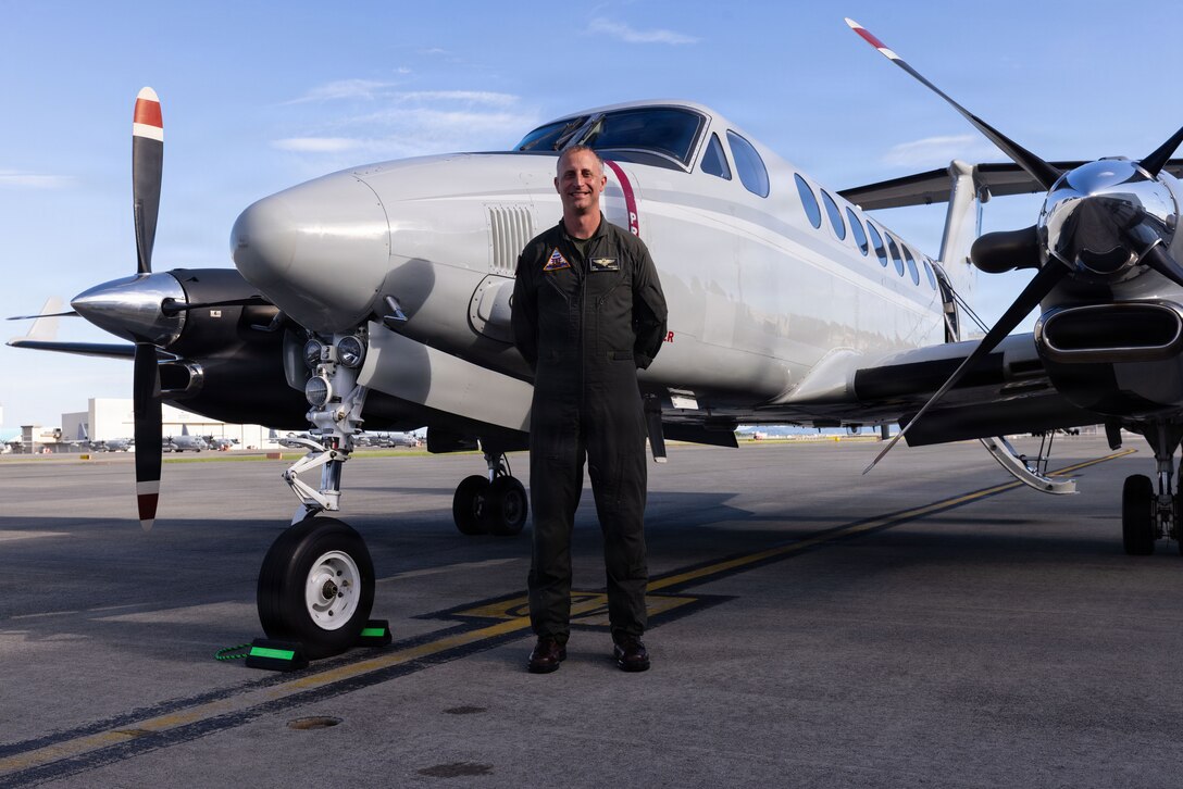 U.S. Marine Corps Lt. Col. Devon Tschirley, the executive officer of Marine Corps Air Station Iwakuni, and native of Spokane, Washington, poses for a photo in front of a UC-12W Huron aircraft after his final flight at MCAS Iwakuni, Japan, July 28, 2026. A commander’s final flight is a long-standing aviation tradition marking the end of their tour of duty. (U.S. Marine Corps photo by Cpl. Ella Cadby)