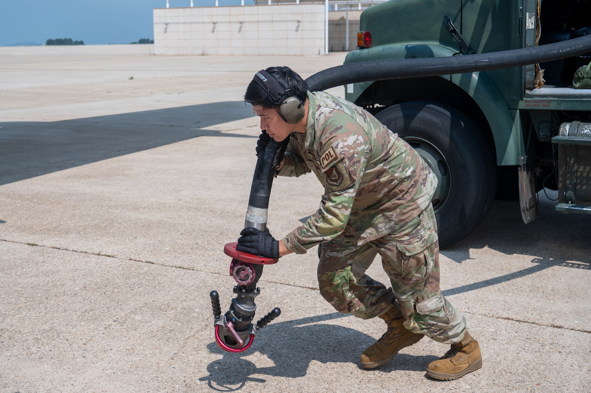 U.S. Air Force Senior Airman Josue De La Rosa, 8th Logistics Readiness Squadron fuels distribution operator, brings a fuel hose to an aircraft for refueling at Kunsan Air Base, Republic of Korea, Aug. 6, 2026. De La Rosa was selected as the Wolf Pack’s "Pride of the Pack" for the week of Aug. 3-7 due to his willingness to step outside his normal duties to assist his wingmen in getting the mission done. (U.S. Air Force photo by Staff Sgt. Cedrique Oldaker)