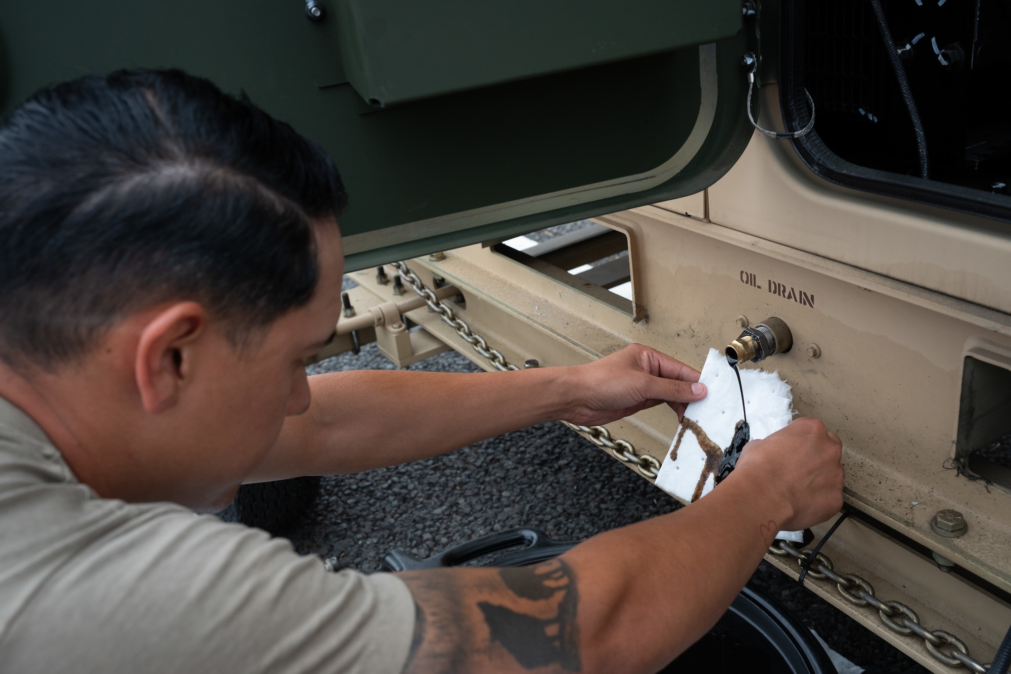 A Pathfinder drains oil from a generator during scheduled maintenance at RAF Fairford, England, Aug. 4, 2026. Routine maintenance keeps critical equipment operational and ready to support the mission. (U.S. Air Force photo by SrA Adam Enbal)