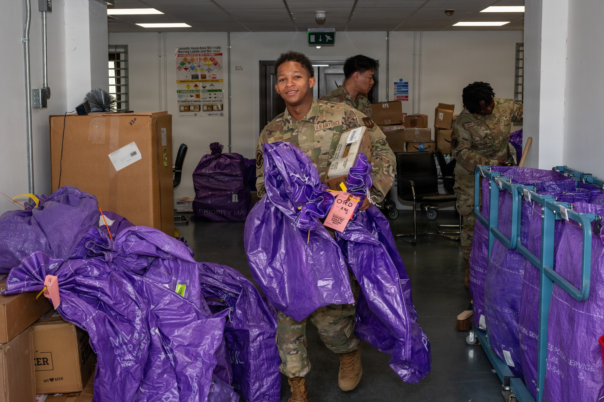 U.S. Air Force Airman 1st Class Valentino Shine, a 420th Air Base Squadron military postal clerk, sorts incoming packages at the RAF Fairford Post Office, England, Aug. 5, 2026. The post office helps deliver morale by connecting service members and their families through reliable mail services. (U.S. Air Force photo by Senior Airman Adam Enbal)