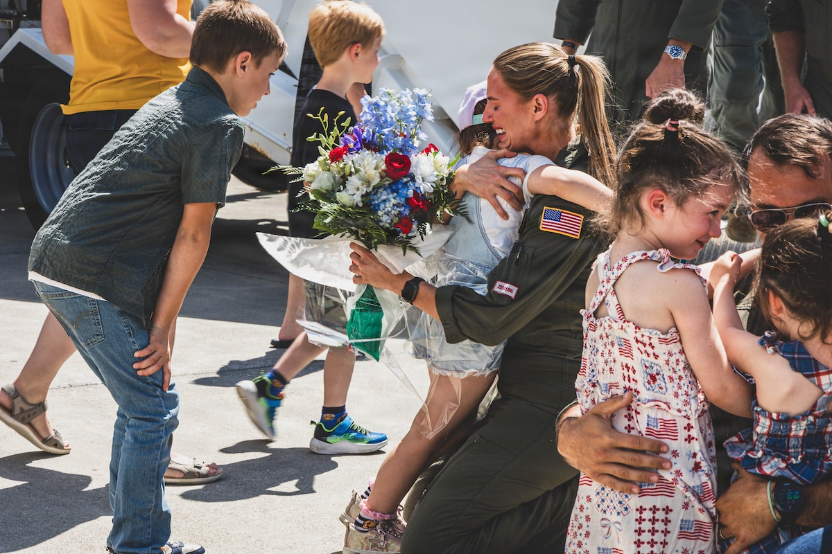 Recently deployed Airmen hug their families after returning to Bangor Air National Guard Base, Maine, July 27, 2026. The Airmen returned home following a routine deployment to an undisclosed location in Europe. (U.S. Air Force photo by Senior Master Sgt. Andrew Sinclair)