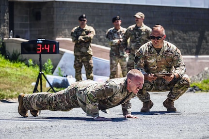 Staff Sgt. Philip Slick performs pushups under pressure during the 101st Air Refueling Wing Security Forces Squadron Best Defender Competition in Bangor, Maine, July 27, 2026. The competition tested security forces Airmen's proficiency in land navigation, marksmanship, tactical fitness, doctrine knowledge and endurance. (U.S. Air Force photo by Senior Master Sgt. Andrew Sinclair)