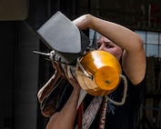 Airman 1st Class Kaitlyn Hunter, assigned to the 421st Fighter Generation Squadron, and other Aircraft Armament Systems specialists assigned to the 388th Maintenance Group participate in a quarterly weapons-loading competition at Hill Air Force Base, Utah, July 24, 2026. The competition encourages Airmen to hone their skills while demonstrating the speed and precision required to safely load weapons onto F-35A Lightning II aircraft. (U.S. Air Force photo by Staff Sgt. Nicholas Rupiper)