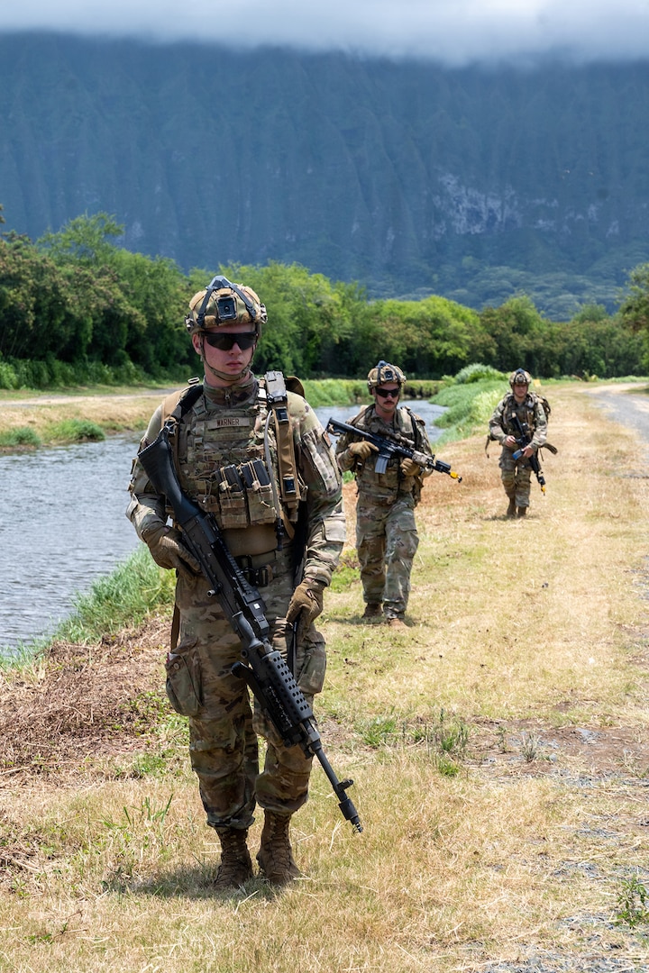 Members of the Colorado National Guard's 140th Security Forces Squadron, or SFS, walk in formation to their next objective during Operation Iron Flag, a hands-on, combat simulation field exercise June 17, 2026, at Bellows Air Force Station, Hawaii.