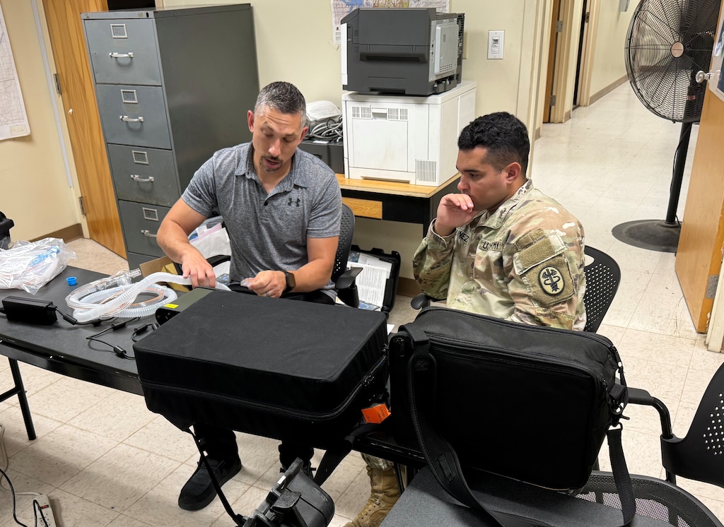 A medical maintenance expert trains an Army Soldier.