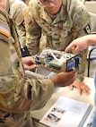 U.S. Army Soldier inspect a medical device during a training event at Fort Bragg, North Carolina.