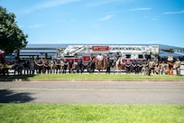 Representatives from local and federal agencies pose for a group photo in front of a fire truck