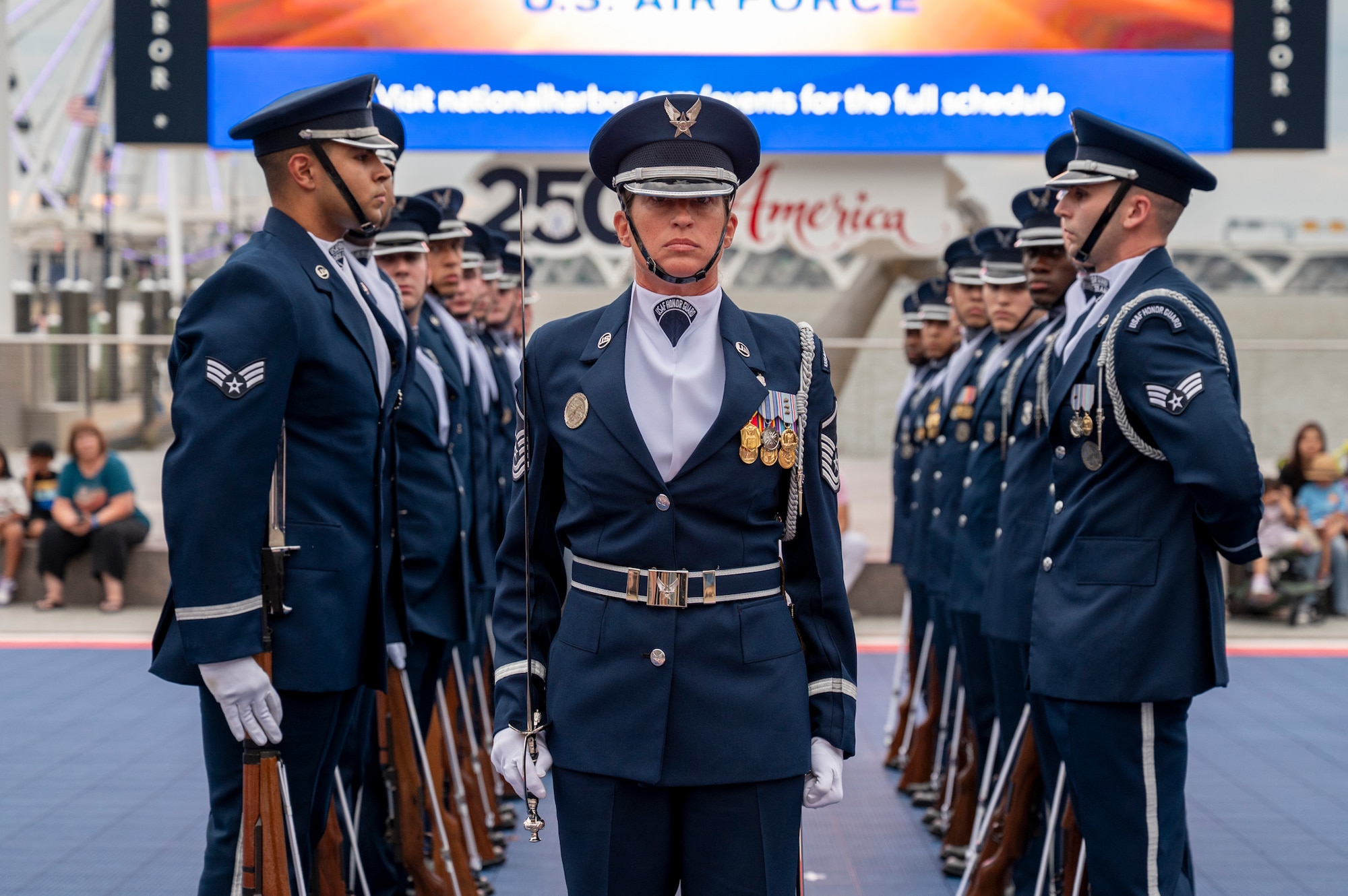 U.S. Air Force Master Sgt stands in the center of a honor guard drill team