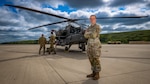 FORT RILEY, Kan. — Army ROTC Cadet Claire Troshynski, a nursing student from Texas Christian University, poses in front of an AH-64 Apache helicopter at Marshall Army Airfield, July 31. Troshynski, whose career goal is to become an Enroute Critical Care Nurse, toured the airfield alongside other cadets participating in the four-week Nurse Summer Training Program (NSTP) at Irwin Army Community Hospital. Following the ground tour, the cadets took a familiarization flight in a UH-60 Blackhawk helicopter over the Kansas Flint Hills to experience the environment of Army aviation and airborne medical transport.